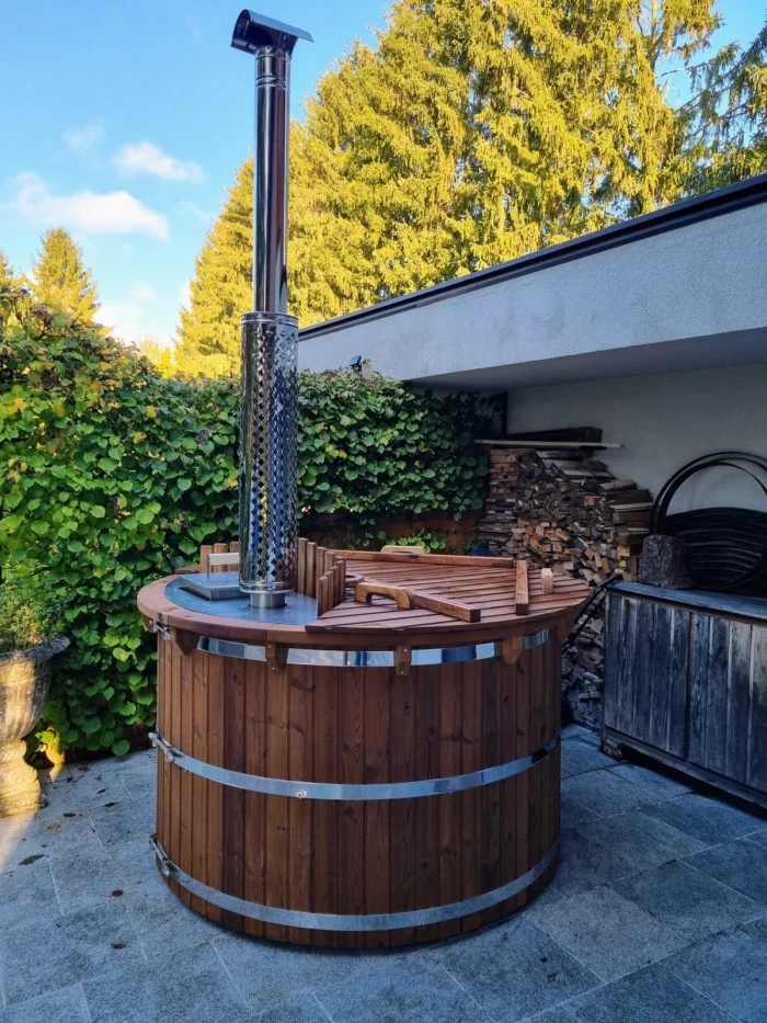 Houten hottub naast een huis met houtopslag